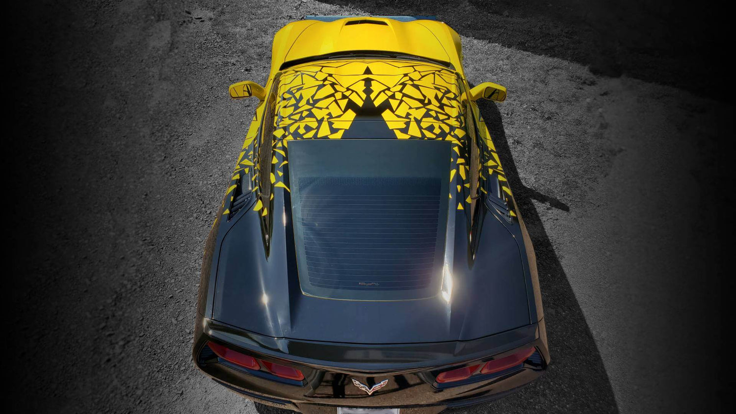 Sports car with yellow and black colored vinyl wrap.